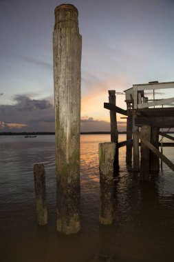 Sahilde gün batımında gökyüzü olan ahşap iskele