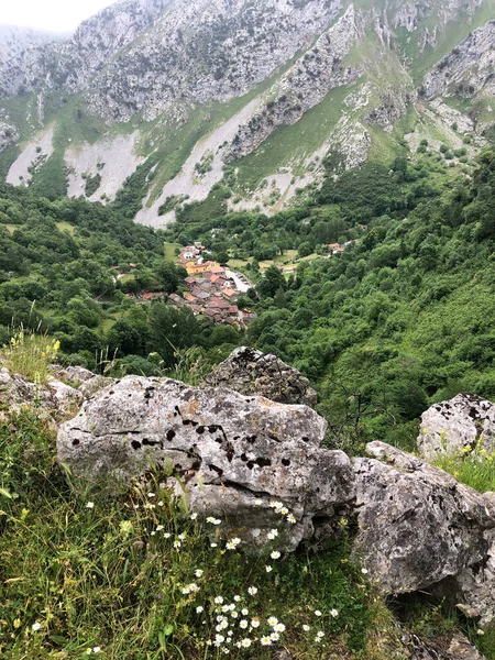 Farming village in the valley between high mountain peaks