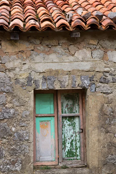 Old wooden window of the stone house