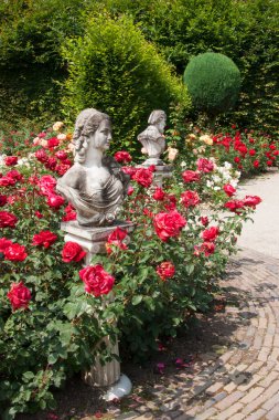 Botanik bahçesi manzaralı, heykeller ve çiçek açan.