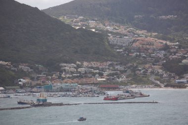 Sahil kenti limanı manzarası tepelerde tekne ve binalar var.