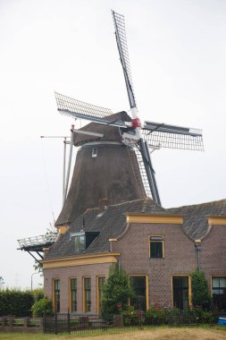 Tuğla taşı üzerinde tipik bir Hollanda kum değirmeni standart ve desenli kaldırım, rüzgar enerjisi üretmek için dönüştürülmüş