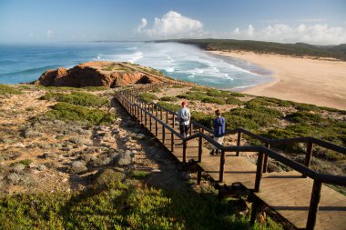 Merdivenlerden deniz kıyısına inen çift.