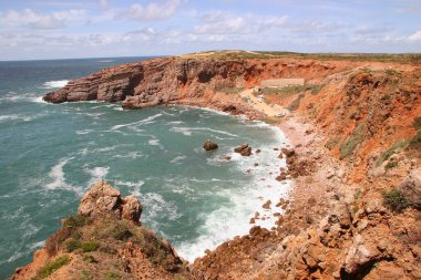 Kayalıkları ve mavi gökyüzü olan güzel sahil 