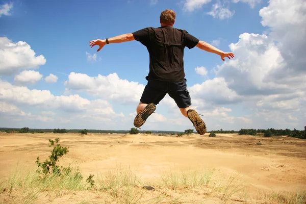 Man Jumping Dirty Road Desert — стоковое фото