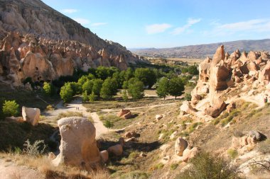 Mağara evleri ve kiliselerden oluşan antik şehir manzarası volkanik kayalara oyulmuş kapılar ve pencereler ve birçok farklı iç odalarla, bazıları çöktü.