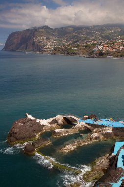 Arka planda deniz manzarası ve plaj.