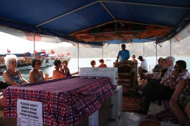 İnsanlar turistik teknede yüzüyor.