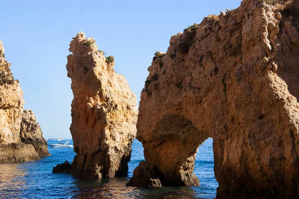 Tipik ve turistik engebeli ve çökmekte olan dengesiz Algarve kayalık kıyıları denizlerde kayalık tepeler, mağaralar, kemerler ve gizli cennet kumsalları