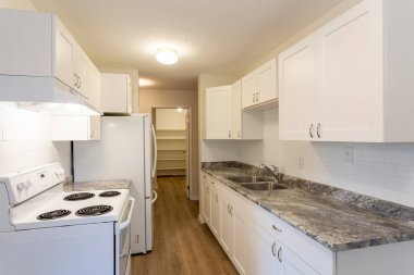 Beyaz duvarları ve yeni sert ahşap kaplama döşemeleri olan yenilenmiş apartman dairesi kiralama ünitesi..