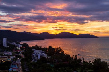 Batu Ferringhi Beach on Penang Island in Malaysia during sunset. clipart