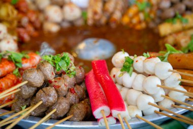 Phuket, Tayland 'da bir markette pişirilmiş et ve deniz mahsulleri sokak atıştırmalıkları ve aperatifleri..