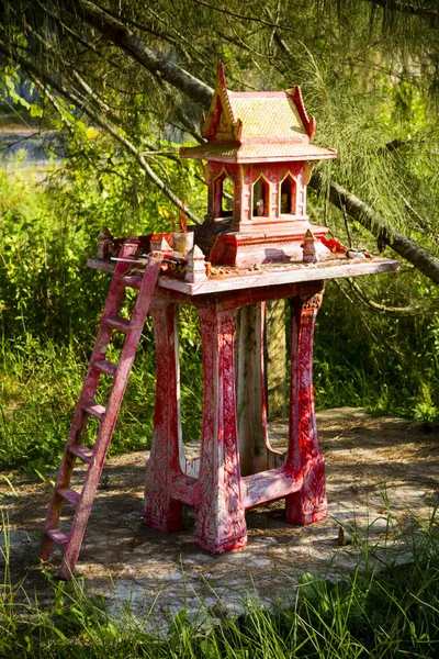 Traditional Thai spirit house in Thailand. A spirit house is a dedicated structure to honor the guardians of the land and is common throughout Thailand.
