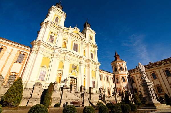 Wide-angle landscape view of ancient Saint Ignatius of Loyola and Stanislaus Kostka church (former Jesuit Collegium).Jesuit Roman Catholic church, designed by Pawel Gizycki and build around 1731-1745.