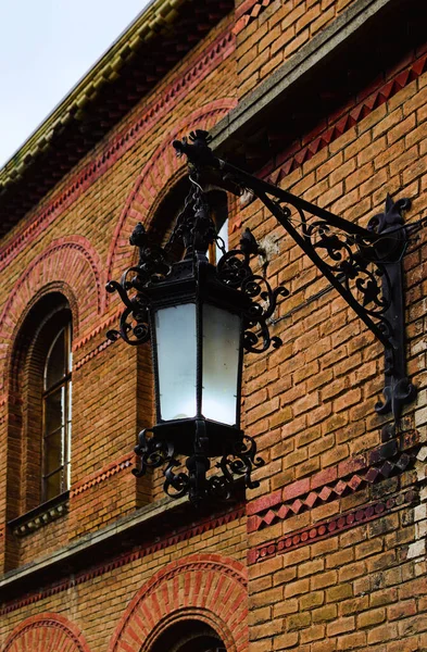 Vintage lantern on the brick wall. Residence of Bukovinian and Dalmatian Metropolitans (Chernivtsi National University).UNESCO World Heritage Site. Chernivtsi, Ukraine.