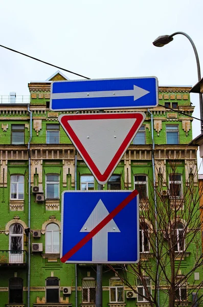 Traffic signs in the city. One way street in direction of right arrow road sign, give way priority yield road sign and end of one way traffic. Concept of road sign.