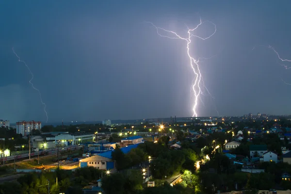 Lightning storm over city in blue light