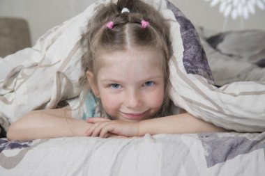 the lovely girl under a blanket