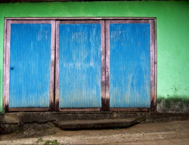 Soluk mavi renkli çok basit bir ev kapısı. 