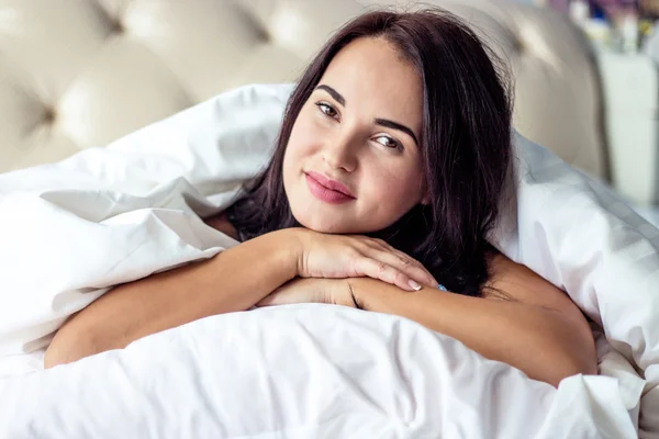 Young beautiful woman lying on the bed, just woke up. Good morning.