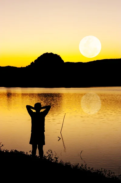 Silhouette some people with the moon — Stock Photo, Image