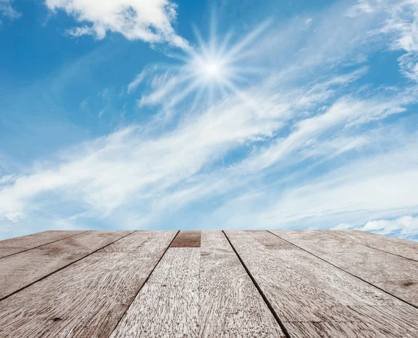 Wooden table top on blue sky — Stock Photo, Image