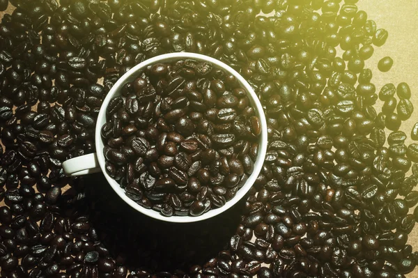 Coffee bean in a white cup — Stock Photo, Image