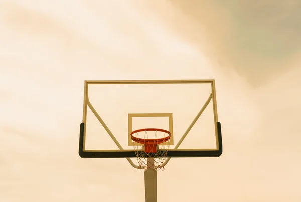 Basketball hoop on empty outdoor court