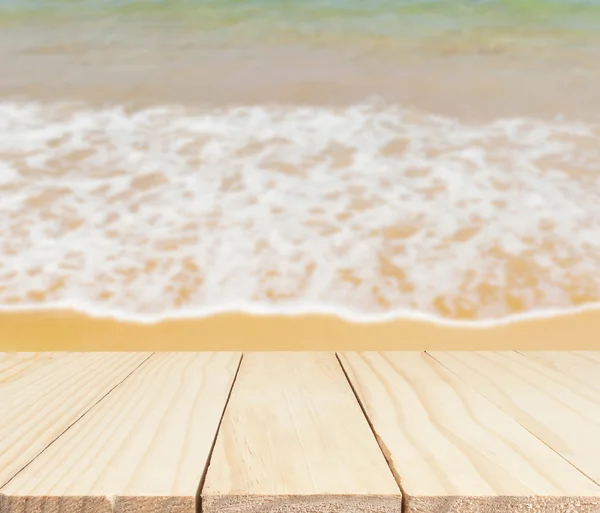 Wood table top on sand beach — Stock Photo, Image
