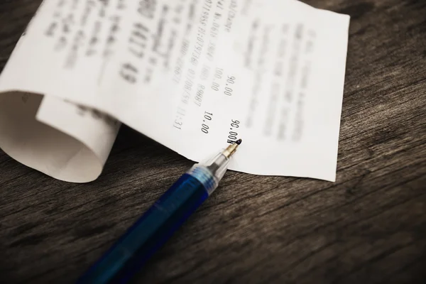 Bill and pen on dark wooden in still life tone — Stock Photo, Image