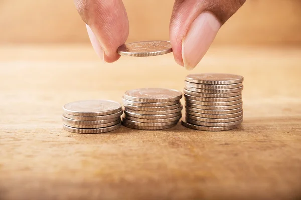 Vintage close up of hand stacking silver coins