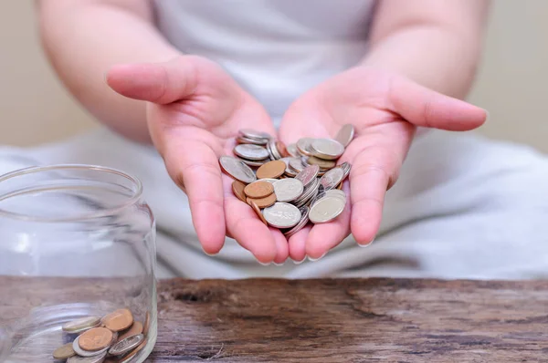 Save money and account banking for finance concept, Hand with coin on blurred background