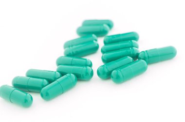 Pills green capsule on a white background