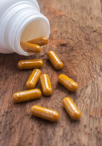 Pills capsule spilling out of a bottle — Stock Photo, Image