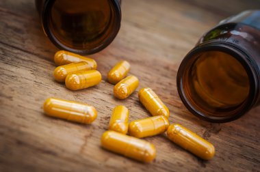 Pills capsule spilling out of a bottle, Still life