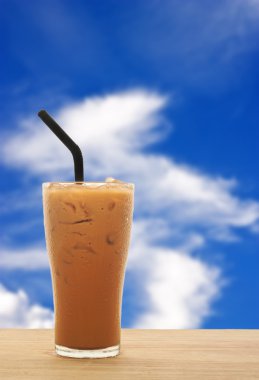 Ice tea on wood with blue sky