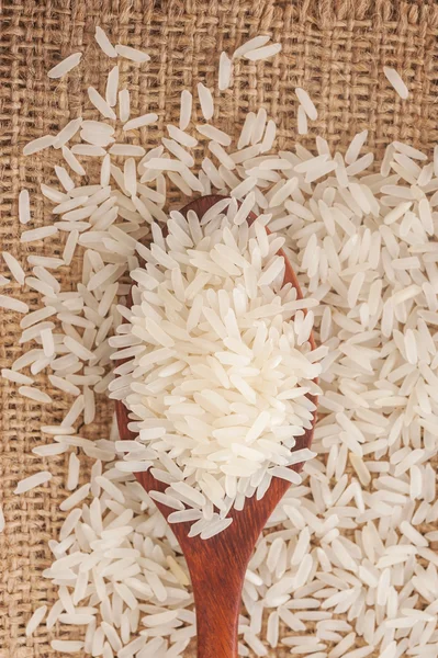 Rice, White rice in wooden spoon on a hemp sack — Stock Photo, Image