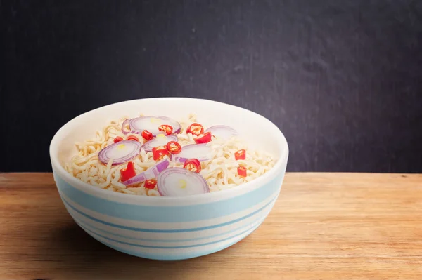 Noodle in bowl on dark wooden background — Stock Photo, Image