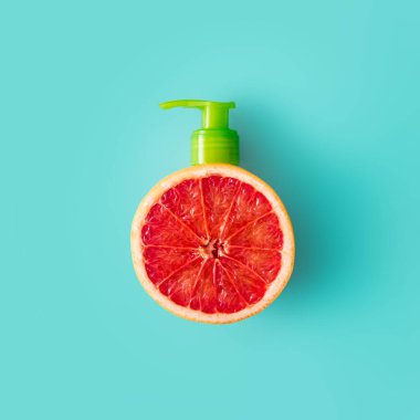 Taze greyfurtla yapılmış yaratıcı pompa dağıtıcısı. Nane arkaplanda en az yaz meyvesi kavramı.