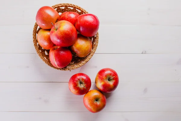 A few apples on a white background with the basket — Stock Photo, Image