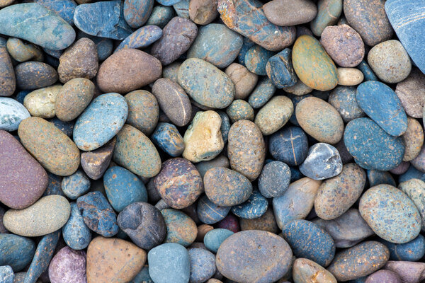 Sea stones background blue violet