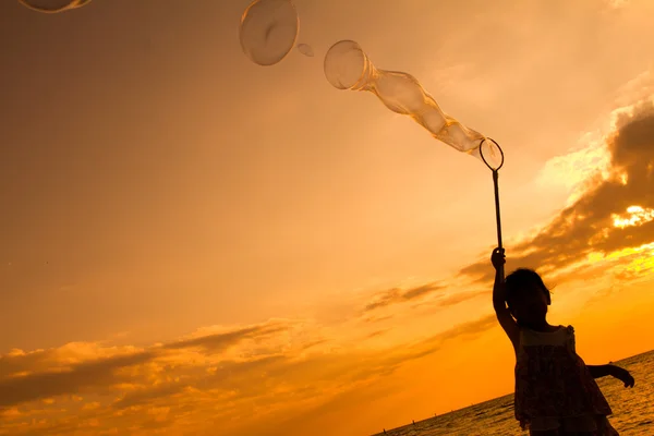 Asian Little Chinese Girl Playing Soap Bubbles on the Beach — Stock Photo, Image