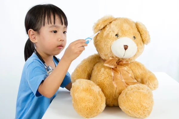 Asiatique petite chinois fille jouer docteur avec peluche ours — Photo