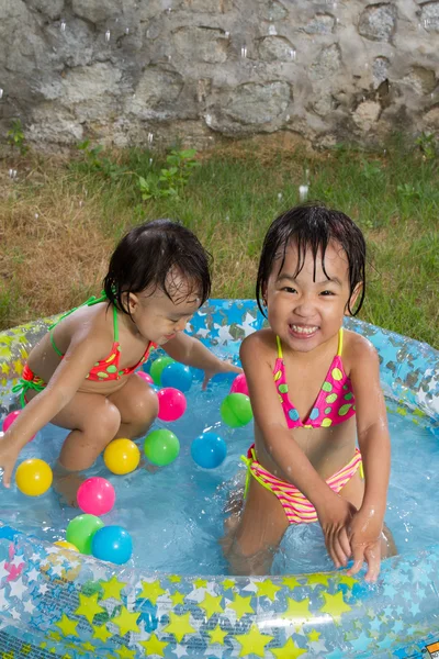 Asyalı küçük Çinli kızlar bir şişme lastik Swimm oynarken — Stok fotoğraf