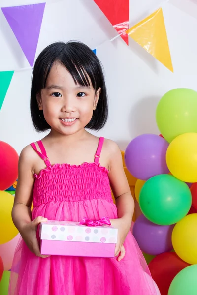 Asiatische kleine chinesische Mädchen mit Geschenkbox und bunten Luftballons — Stockfoto