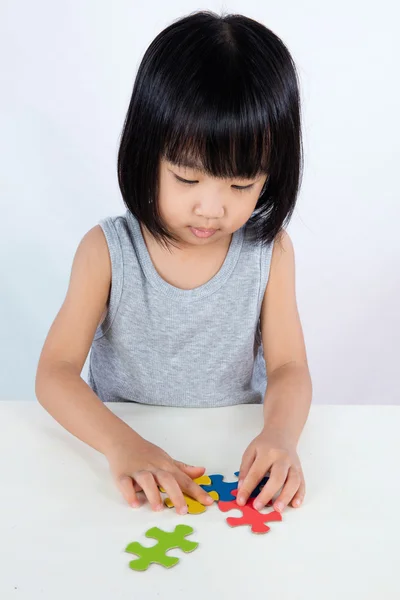 Asiático poco china chica jugando colorido rompecabezas — Foto de Stock