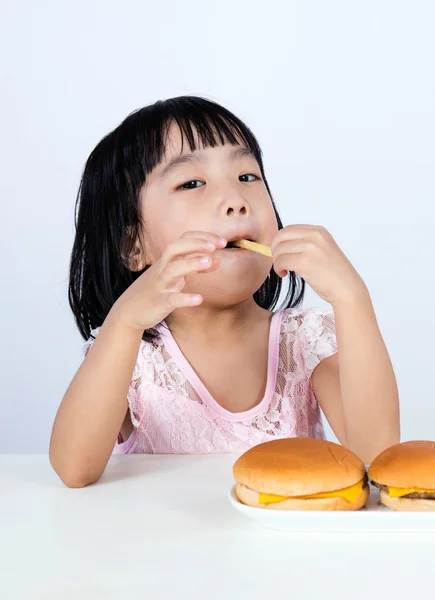 Asian Chinese little girl Eating French fries — Stock Photo, Image