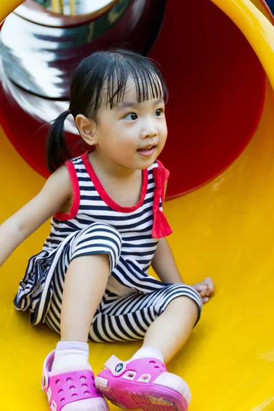 Asian kid sliding on Playground — Stock Photo, Image