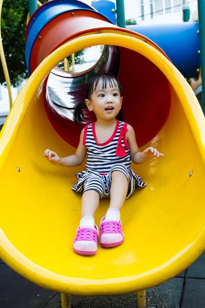 Asian kid sliding on Playground — Stock Photo, Image