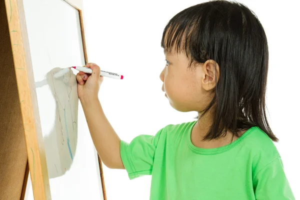 Chinese little girl writing on whiteboard — Stock Photo, Image